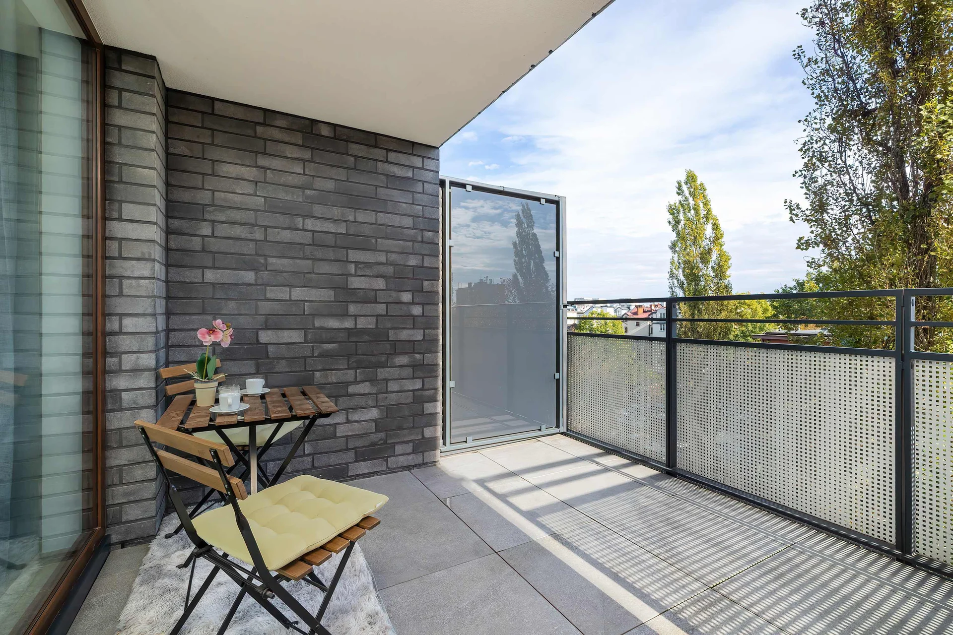 The balcony with a comfortable seating set is the perfect spot for a morning coffee in the sun or an evening moment of relaxation outdoors.