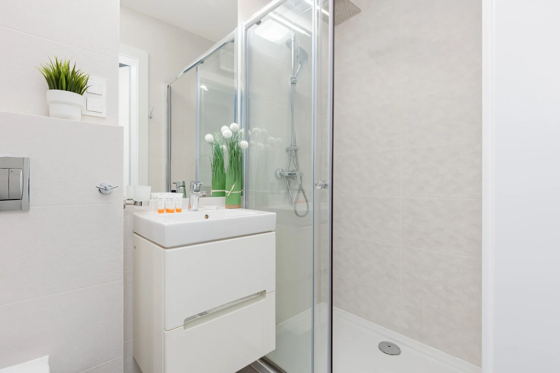 Bathroom with washing machine and towels.