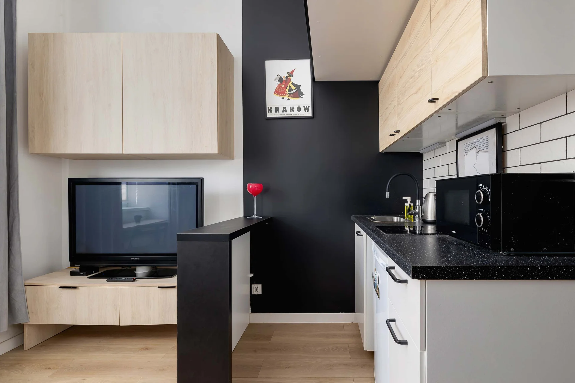 A kitchenette, separated by a countertop from the lounge area.