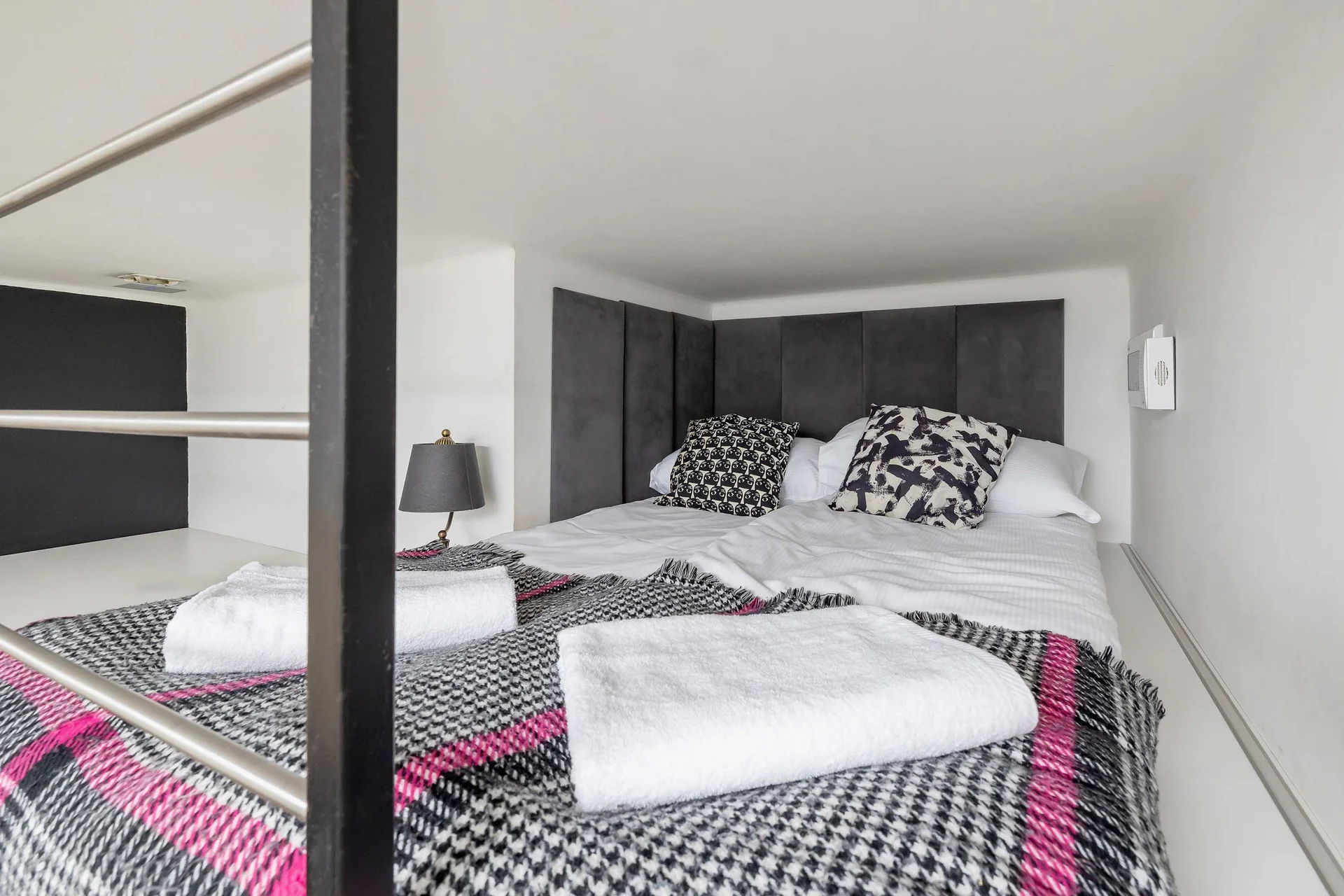 A cozy sleeping space on the mezzanine, with a large bed and soft bedding for a comfortable rest.