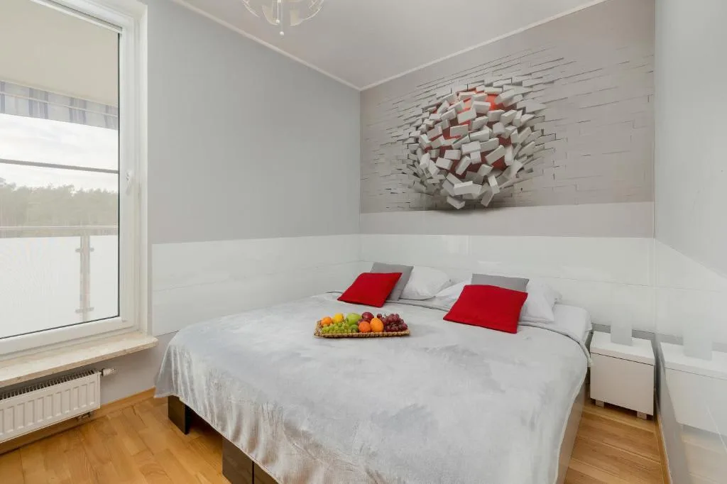 A cosy, bright bedroom with a double bed.