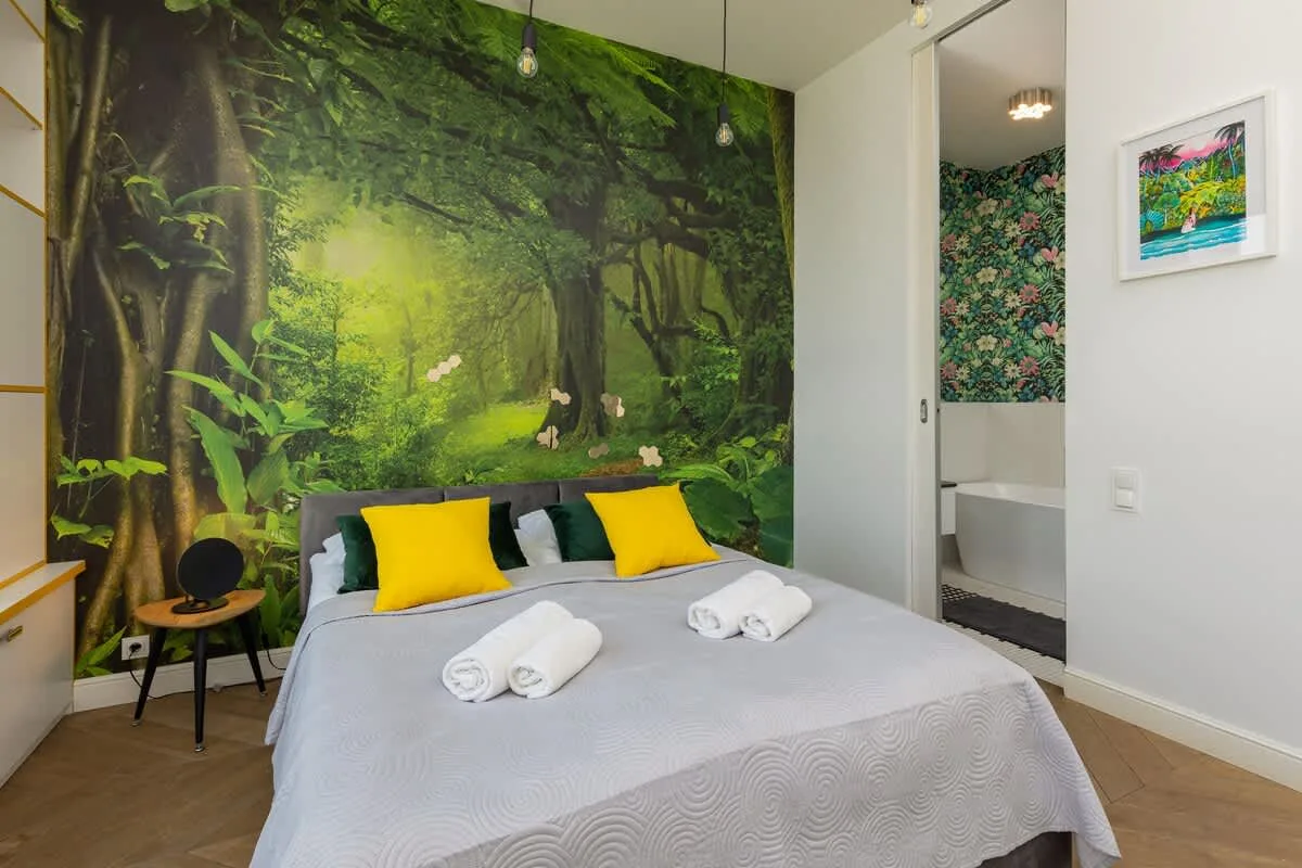 Bedroom with a large, comfortable double bed, sofa and a private bathroom.