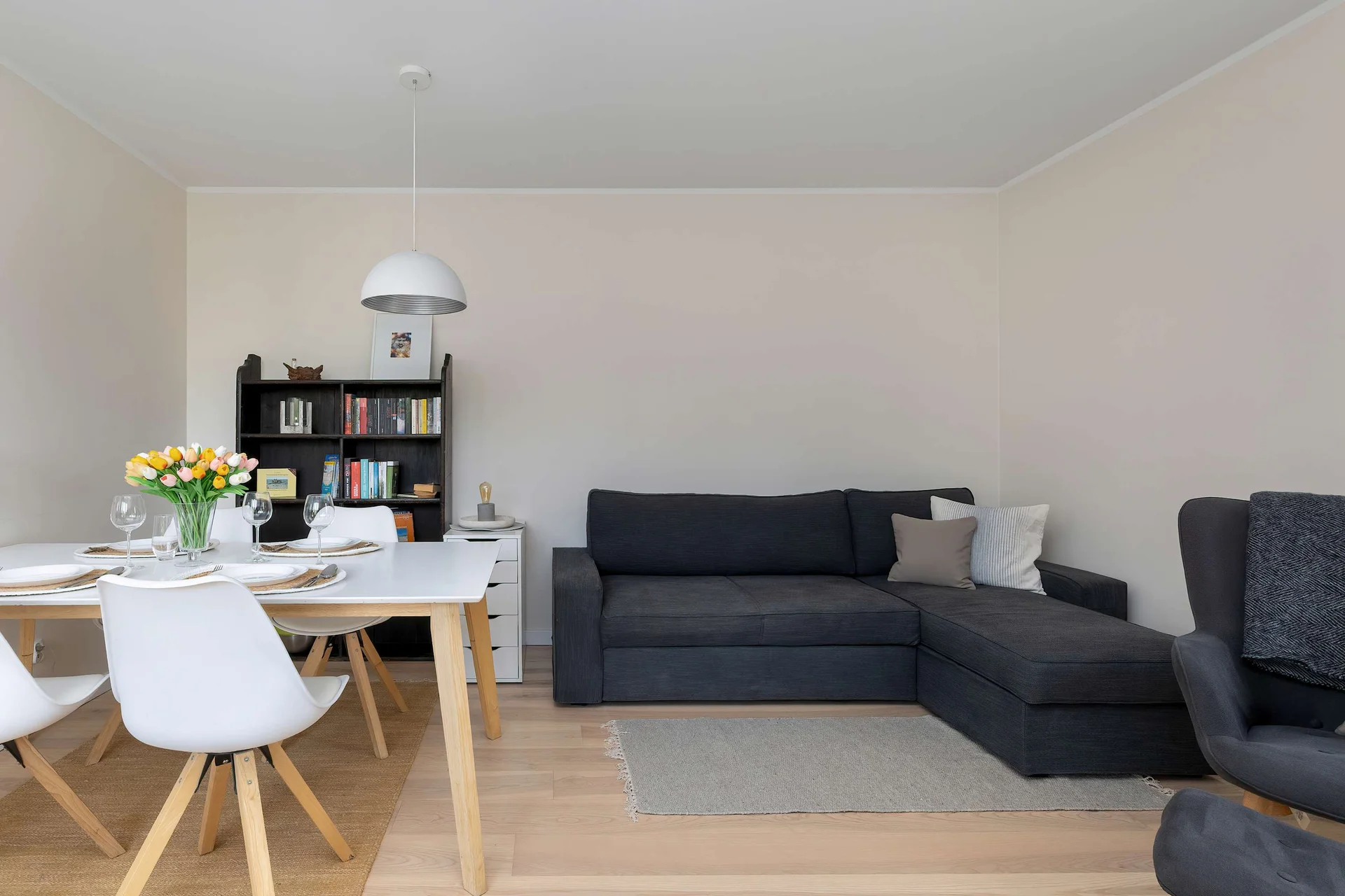 Bright and spacious living room with a comfy sofa and armchair.