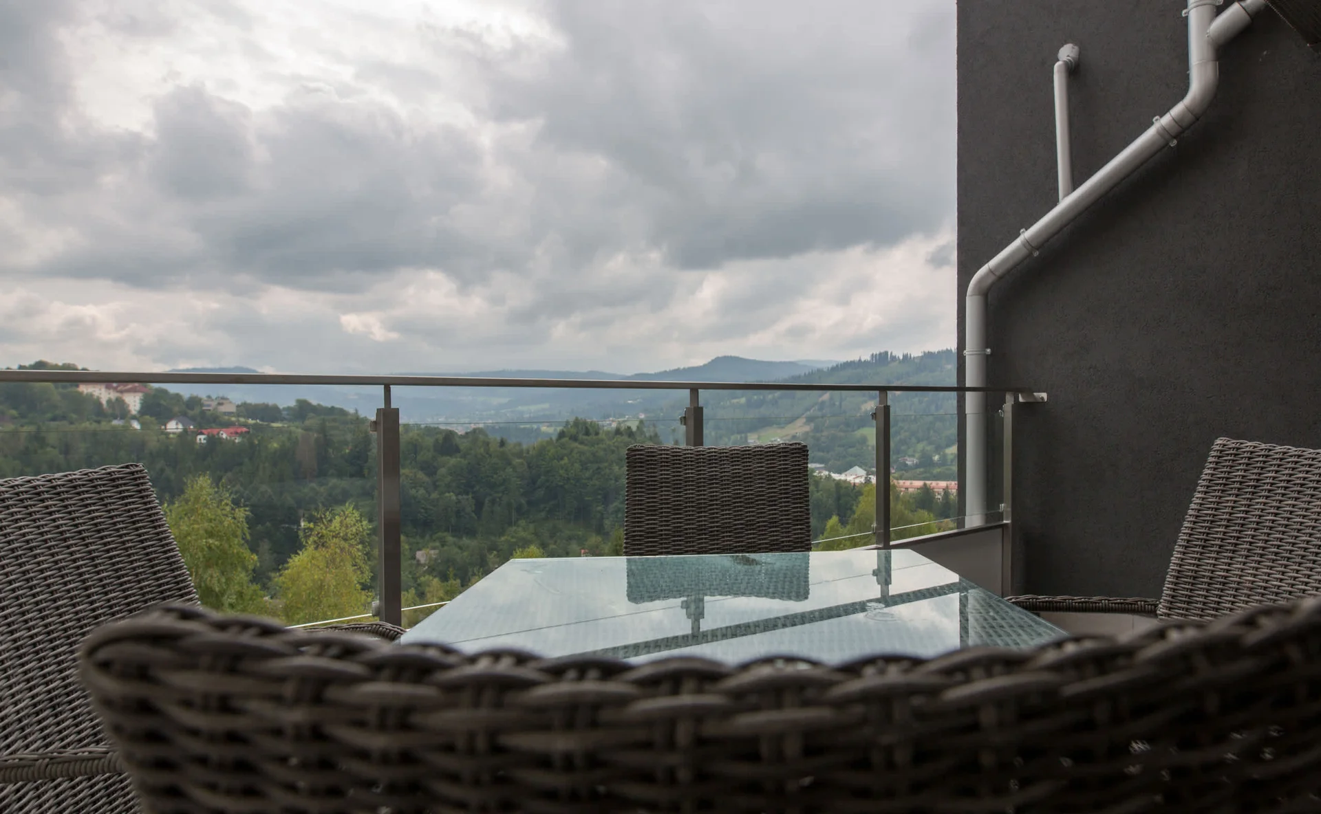Spacious balcony with outdoor furniture.