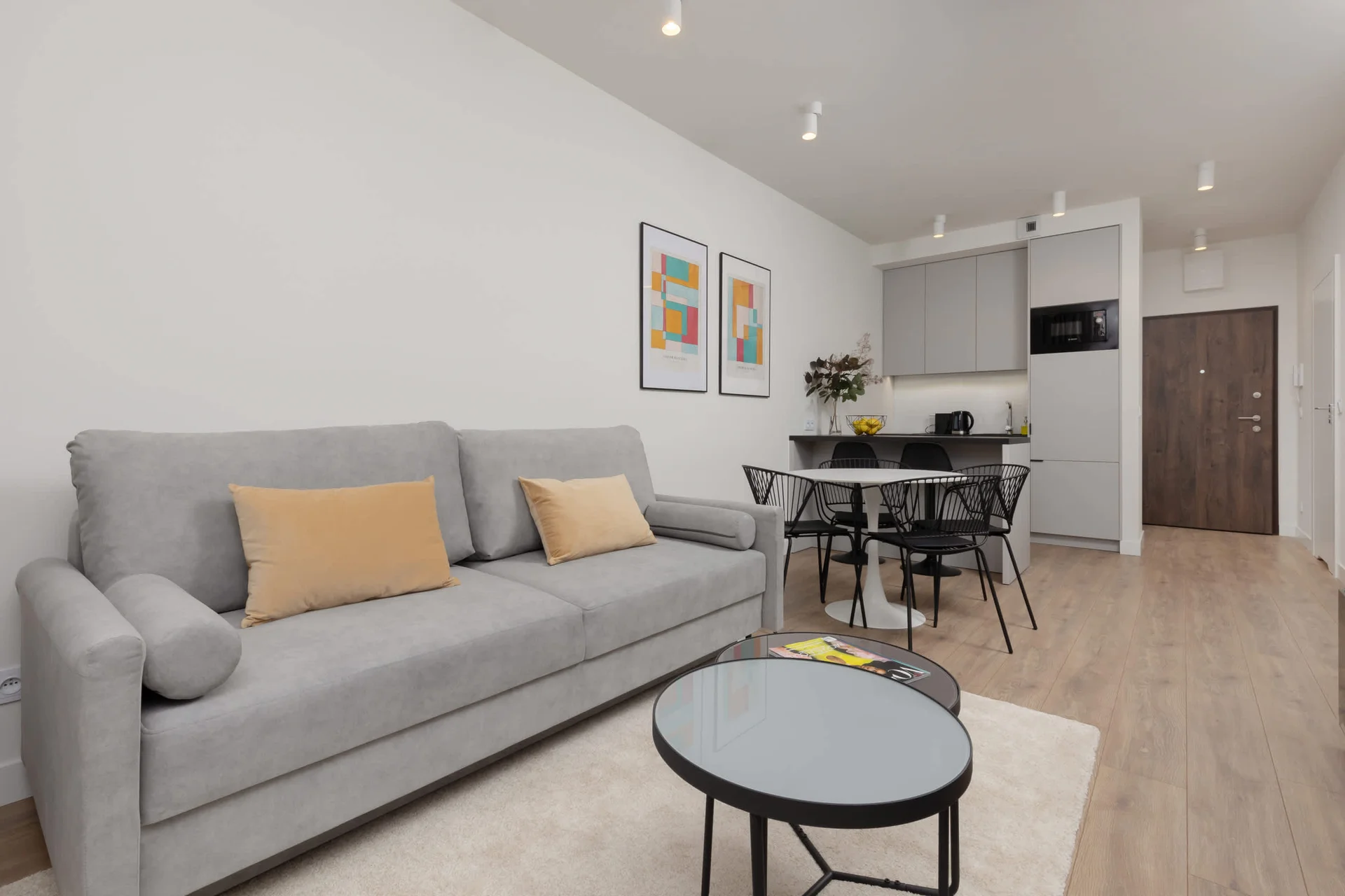Relax in the stylish living room with a comfortable sofa and modern decor.