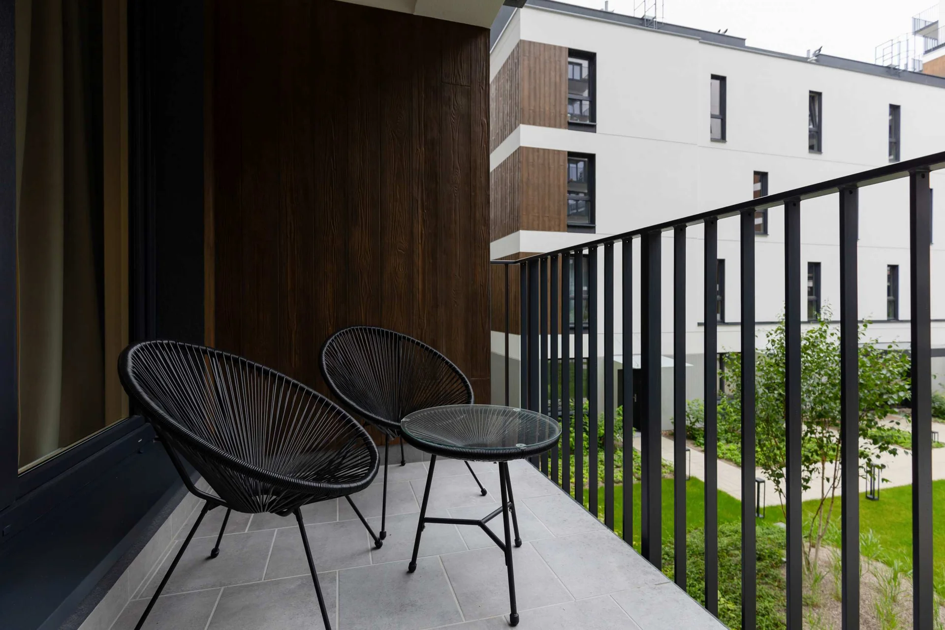 The balcony's stylish design complements the apartment's decor.