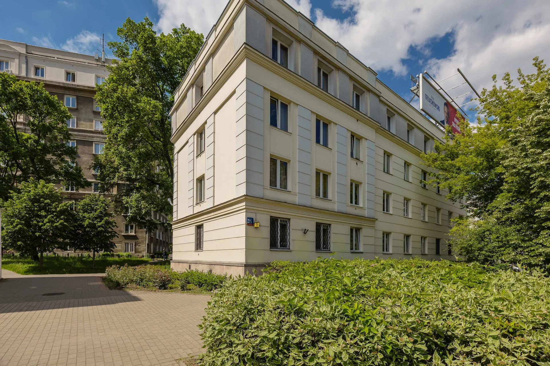 The building is modern, well-maintained, and surrounded by a quiet, green courtyard.