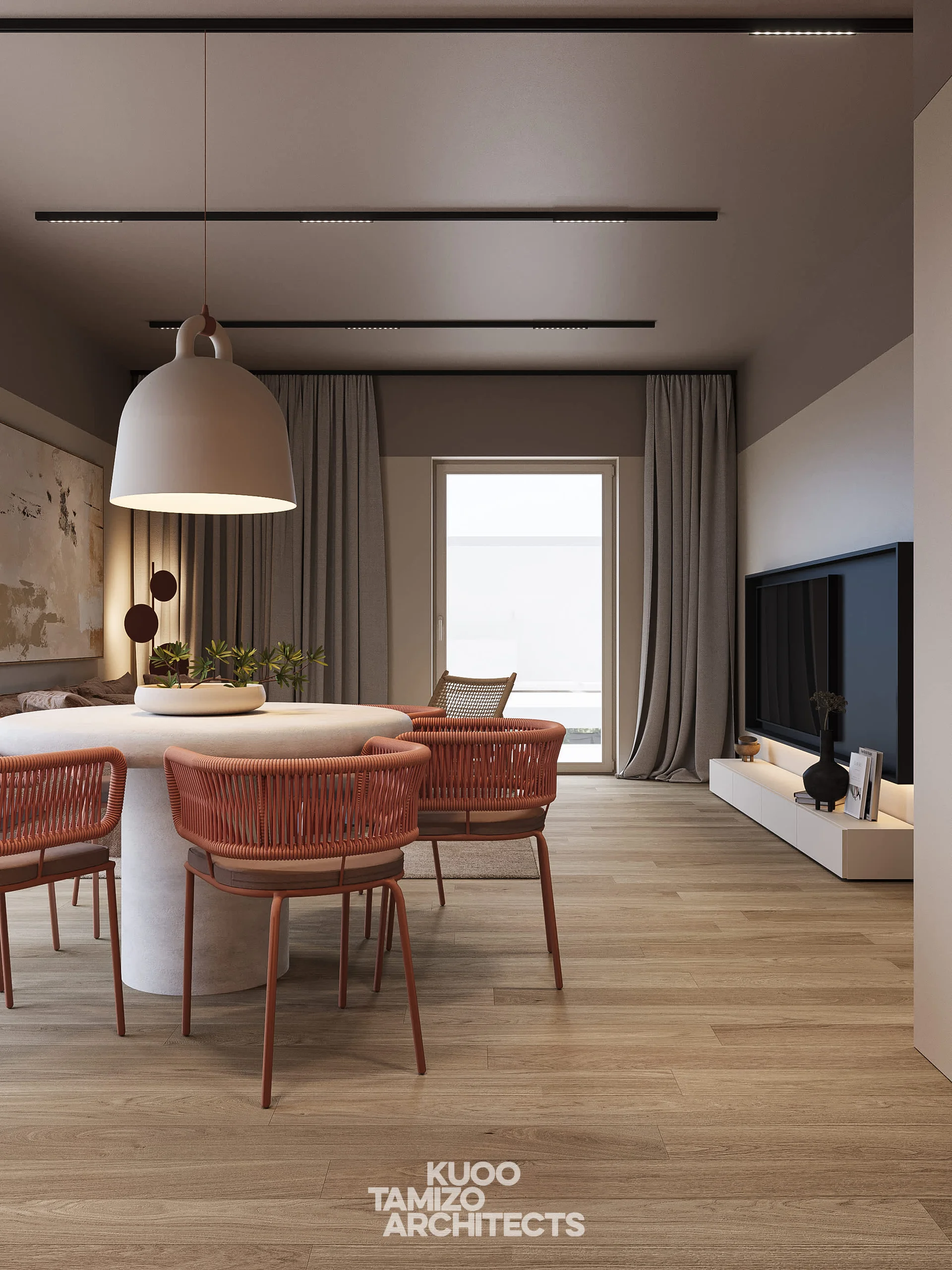 A round dining table with four woven chairs serves as a central gathering point under a stylish pendant lamp.