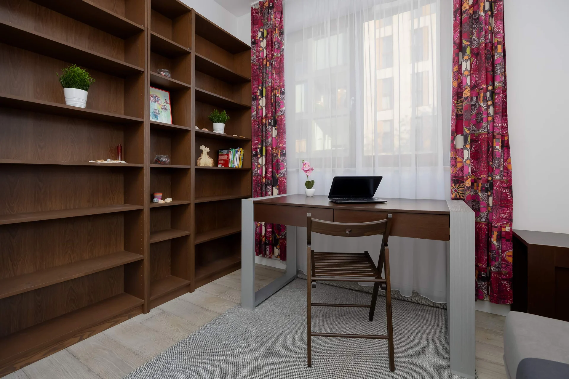 Workspace with desk and shelving unit.