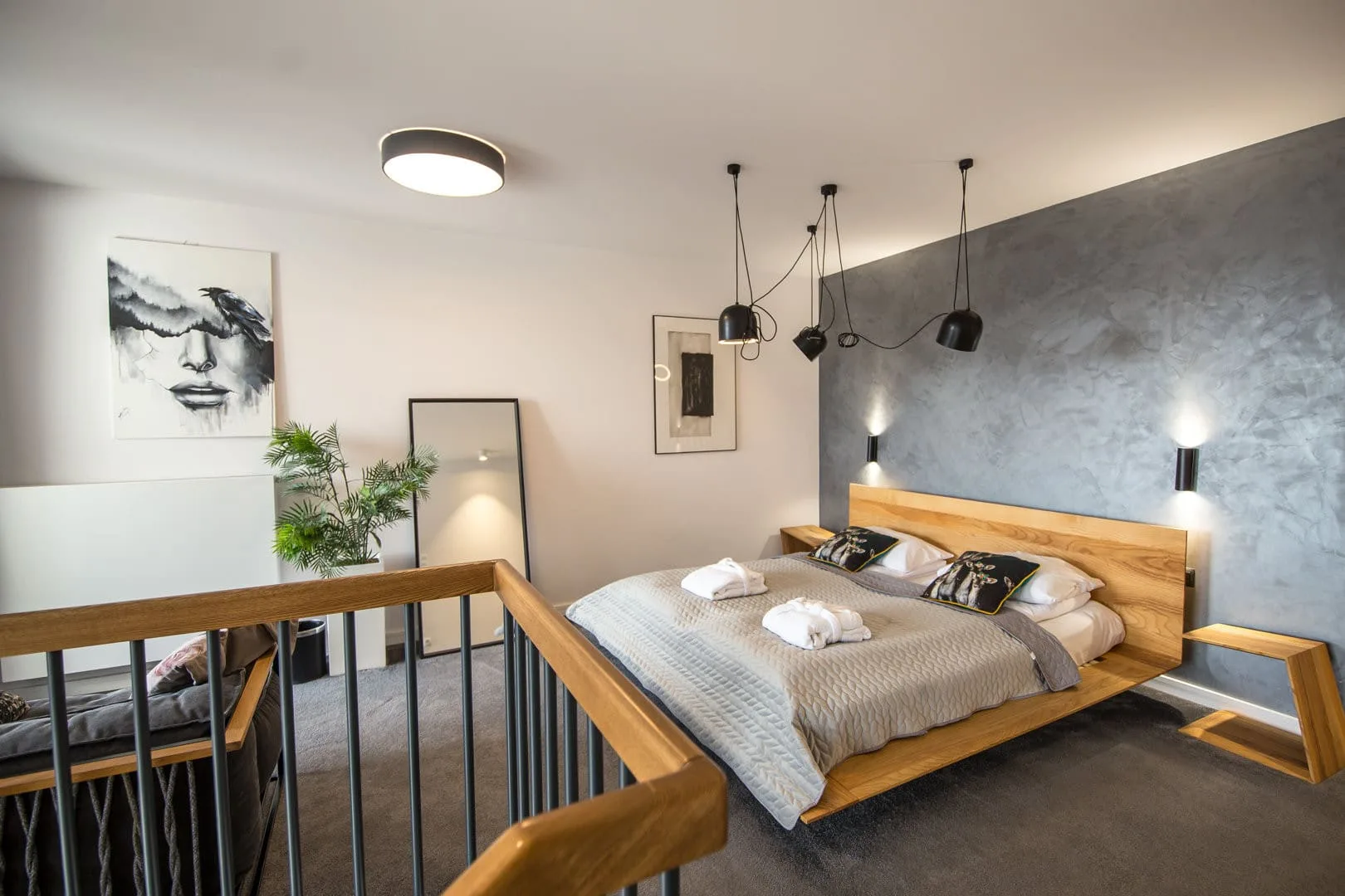 The bedroom with soft bedding and designer lighting provides a sense of intimacy and comfort after a day full of experiences.